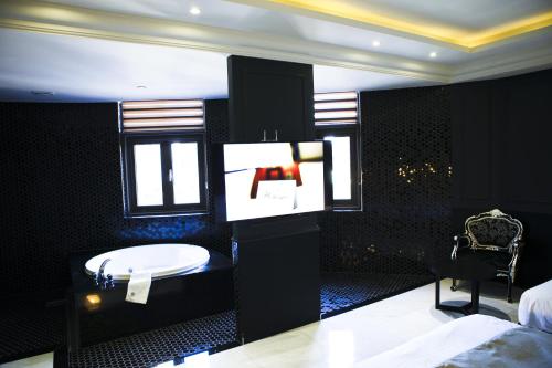 a bathroom with a bed and a sink in a room at Hotel Doma Myeongdong in Seoul