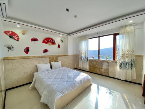 a bedroom with red umbrellas on the wall at ZoZo House - Homestay Bai Sau 77 in Vung Tau