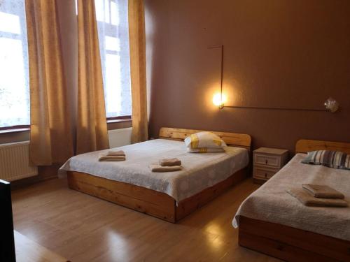 a bedroom with two beds with towels on them at Hotel Ludza in Ludza