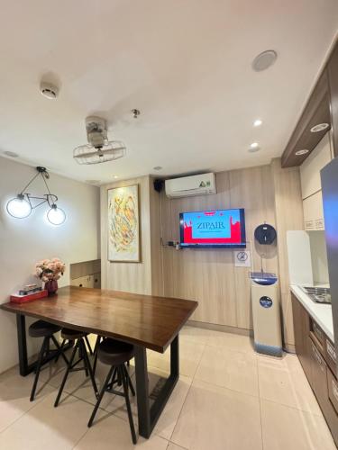 a dining room with a table and a tv at Toi's Travel Home Central in Ho Chi Minh City