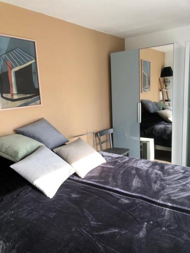 a bedroom with a bed with two pillows on it at Cocoloclouvigny in Louvigny
