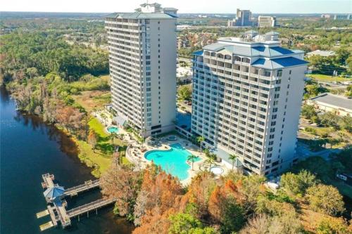 an aerial view of two tall buildings next to the water at Blue Heron Beach Resort pet friendly in Orlando