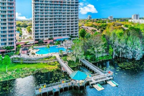 an aerial view of a resort on the water with buildings at Blue Heron Beach Resort pet friendly in Orlando