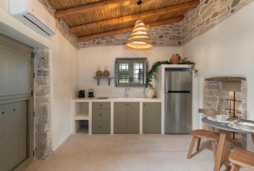 a kitchen with a sink and a refrigerator at St-Ten Stone Built Village in Áyioi Dhéka