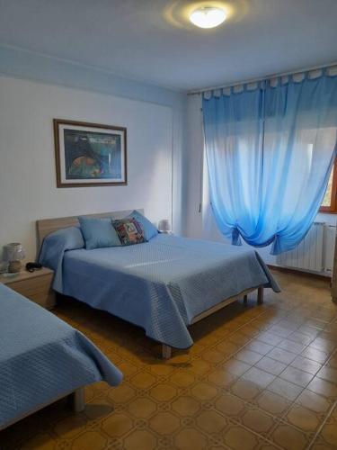 Ένα ή περισσότερα κρεβάτια σε δωμάτιο στο L'angolo verde