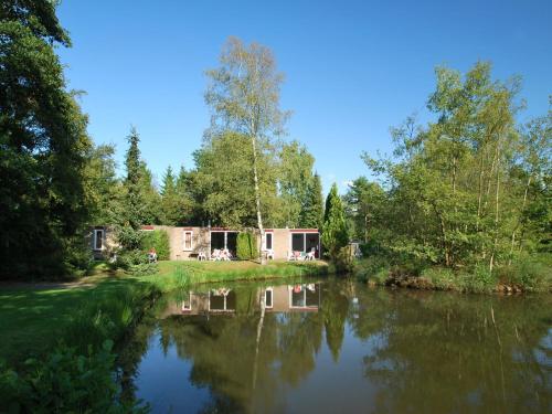 a house on the side of a river at Tidy bungalow with garden located in natural area in Vledder