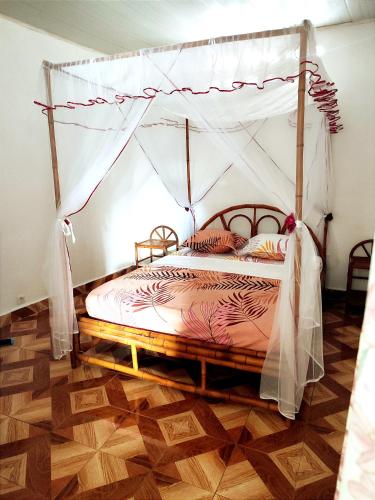 a bedroom with a bed with a canopy at VILLA KIMRAN in Mahajanga
