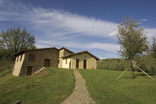an old stone house on a hill with a path at Tenuta il Cerro in Vicchio