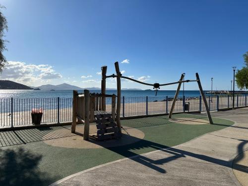 a playground on the beach next to the water at Athens Sea Front Apartment, Varkiza in Varkiza