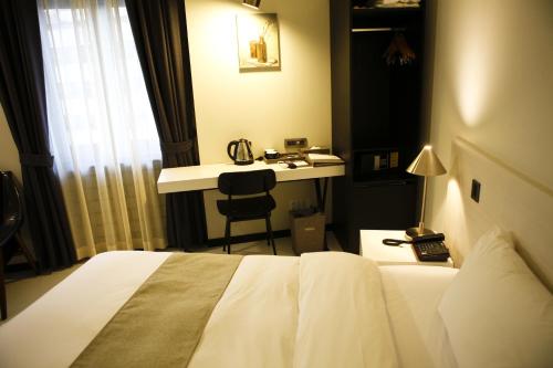 a hotel room with a bed and a desk at Hotel Doma Myeongdong in Seoul