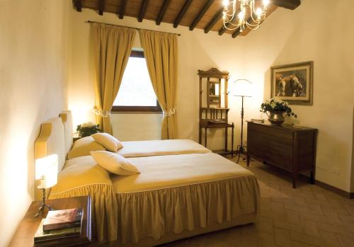 a bedroom with a large bed and a window at Tenuta il Cerro in Vicchio