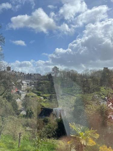 a view of a waterfall on a hill with a city at Demeure exceptionnelle proche du château de Vire in Vire