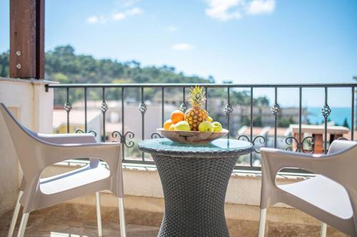 a bowl of fruit on a table on a balcony at Guest House S-Lux in Petrovac na Moru