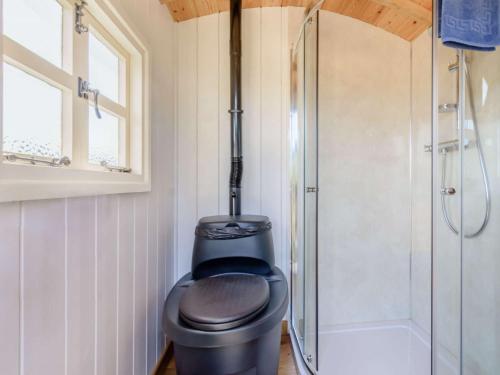 a bathroom with a black toilet and a shower at 1 Bed in Horam 88900 in Horam
