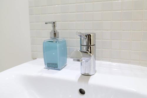 a soap dispenser sitting on top of a bathroom sink at Serviced Apartment In Liverpool City Centre - Free Parking - Balcony - by Happy Days in Liverpool
