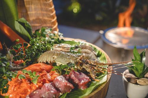 a plate of food with a lobster on it at Anantara Vacation Club Mai Khao Phuket in Mai Khao Beach