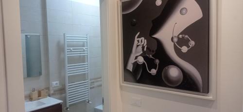 a painting of a bathroom with a sink and a toilet at Gli Amici della Puglia in Taranto