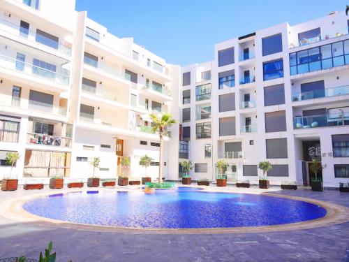 a swimming pool in front of a building at AgadirBay in Agadir