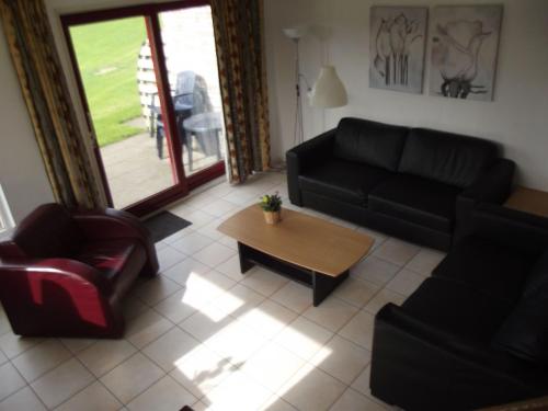 a living room with a couch and a coffee table at Semi detached house in Franeker with a shared pool in Franeker