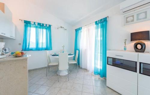 a kitchen with blue drapes and a table in a room at Holiday house in rural Istria with pool and hydromassage in Žminj