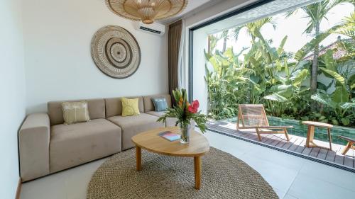 a living room with a couch and a table at Premier Umalas Villas in Seminyak