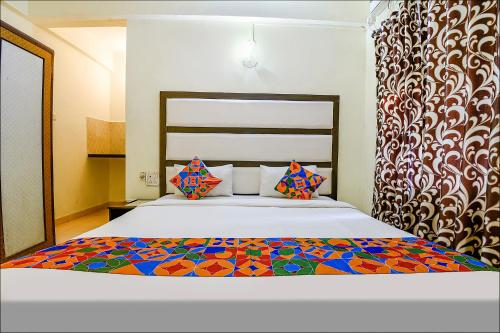 a bedroom with a large bed with a colorful bedspread at FabExpress Jesant Valley Resort in Candolim