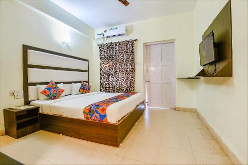 a bedroom with a bed and a television in a room at Via Jesant Valley Resort - Nr Candolim Beach in Candolim