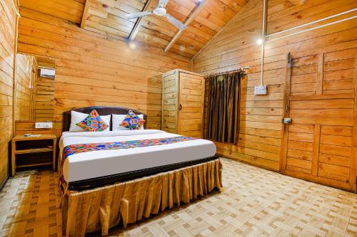 a bedroom with a bed in a wooden room at Via Jesant Valley Resort - Nr Candolim Beach in Candolim
