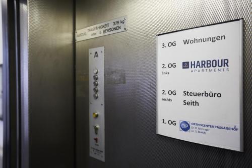 an elevator door with a sign on it at Harbour Apartments in Karlsruhe