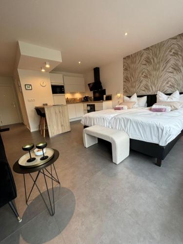 a large bedroom with two beds and a table at Studio de l'Avenue in Spa