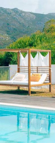 a bed sitting next to a swimming pool at Casa do Alto da Barrosena - Cerveira in Vila Nova de Cerveira