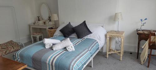 a bedroom with a bed with towels on it at Sail Loft in Brighton & Hove