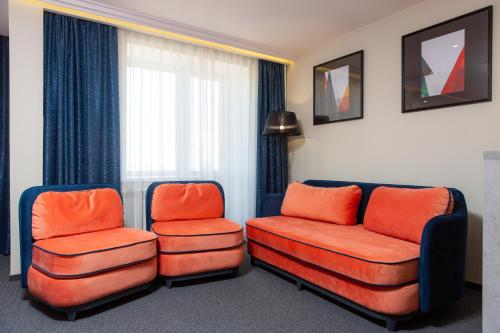 two chairs and a couch in a room at Отель KOKSHETAU in Kokshetau