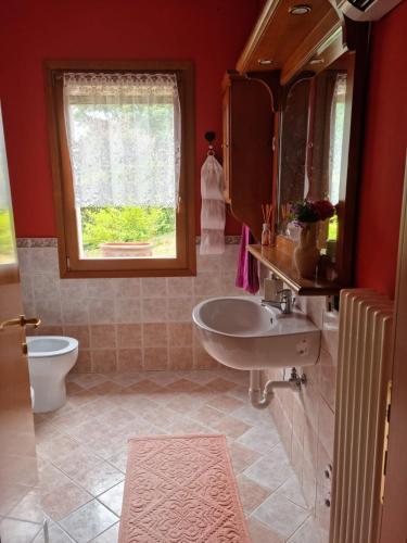 a bathroom with a sink and a toilet and a window at LE BETULLE B&B in Romano D'Ezzelino