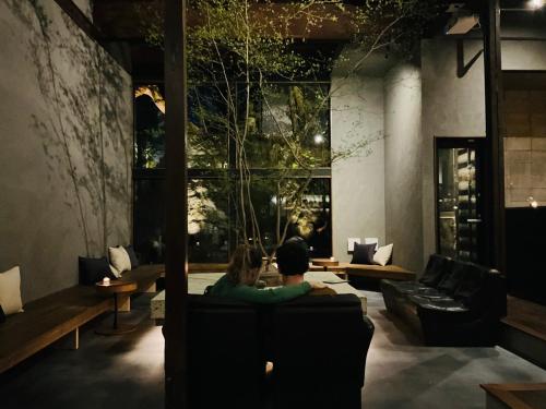 two people sitting on a couch in a room at RoheN HakoneYumoto in Hakone