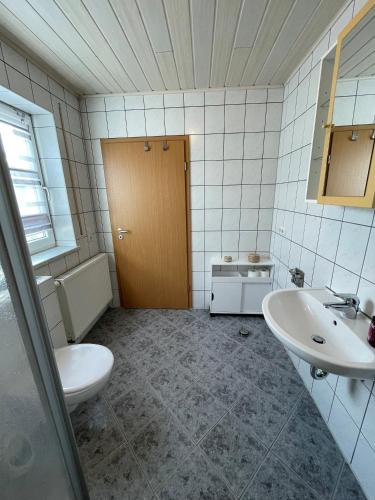 a bathroom with a toilet and a sink at Ferienwohnungen Schiffmann in Pressath