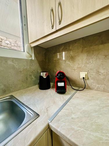 a kitchen counter with a toaster and a sink at Sea view Sarande in Sarandë