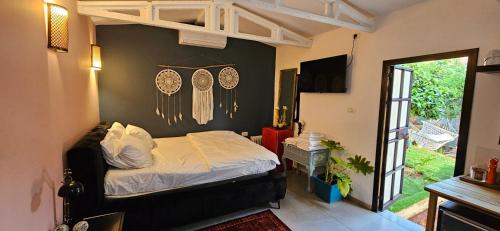 a bedroom with a bed and decorations on the wall at Quiet place 3 km from the beach of Cesarea in Or ‘Aqīvāh