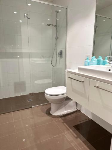 a bathroom with a toilet and a shower and a sink at The Southbank Central Retreat in Melbourne