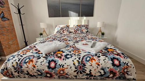1 dormitorio con 1 cama grande y edredón de flores en 2-TUUL ETXEA, Habitación doble a 8 km de Bilbao, Baño compartido, en Galdakao