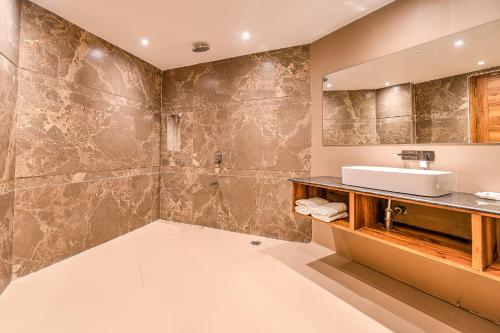 a bathroom with a sink and a mirror at Silver Sand Sea Princess Beach Resort in Manglutān