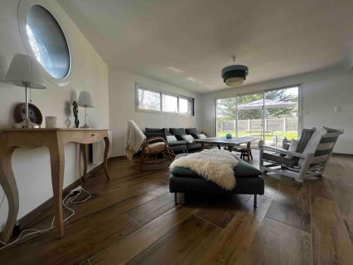 a living room with a couch and a table at La Villa Case-Bi in Saint-Germain-sur-Ay