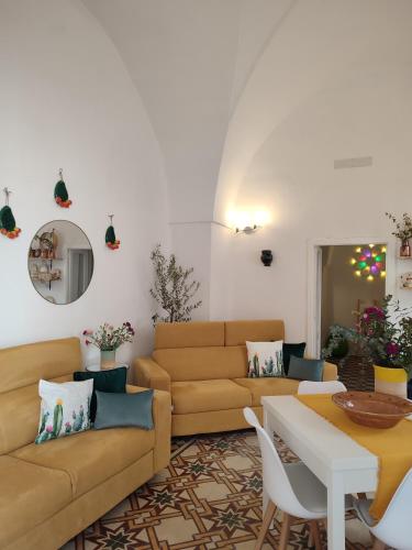 a living room with a couch and a table at Dimora Ludovica in Copertino