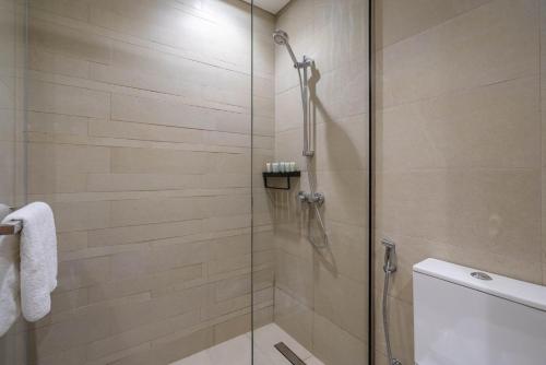 a shower with a glass door in a bathroom at GuestReady - Urban Retreat in Downtown in Dubai