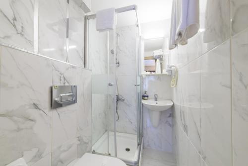 a bathroom with a shower and a toilet and a sink at Naz Wooden House Inn in Istanbul