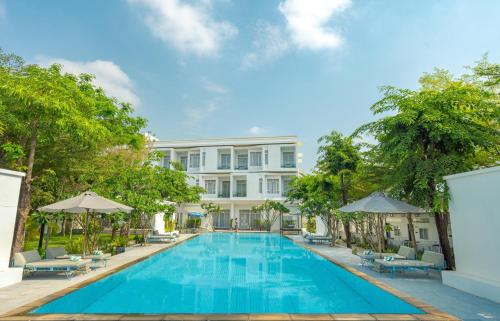 an image of a swimming pool in front of a building at Elysium Suite in Siem Reap