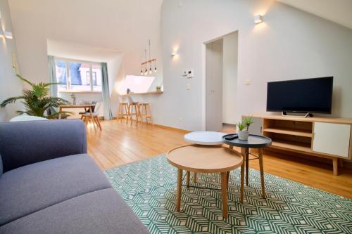 a living room with a couch and a table at Heart of Grand Place - Stunning 2BR Duplex in Brussels