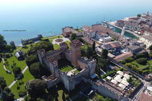 an aerial view of a castle in front of the ocean at Tulipano Apt - Palazzo Palermo 1817 - Happy Rentals in Salionze
