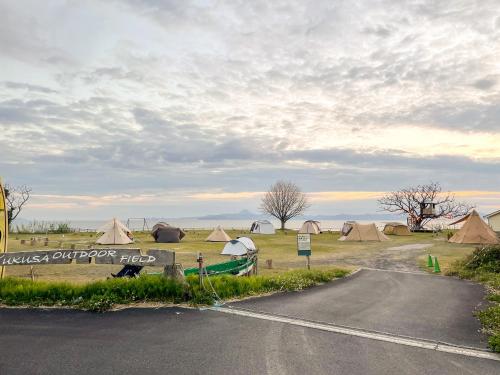 a road with a group of tents in a field at YUKUSA OHSUMI UMI no GAKKO in Kanoya