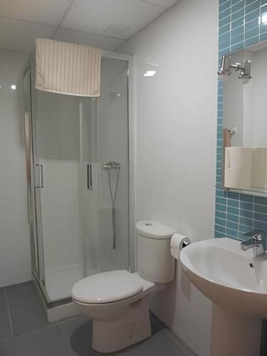 a bathroom with a toilet and a shower and a sink at Mirador dels Terrers by Tucasanlaplaya in Benicàssim